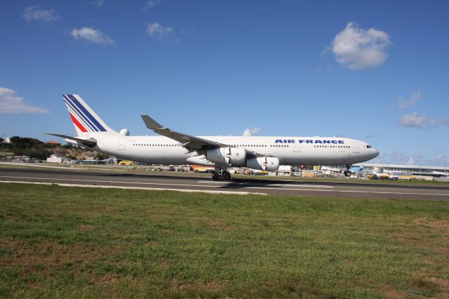 Airbus A340-300 (F-GLZT) - Thrust reversers deploy before the nose settles onto the runway at St Maarten.