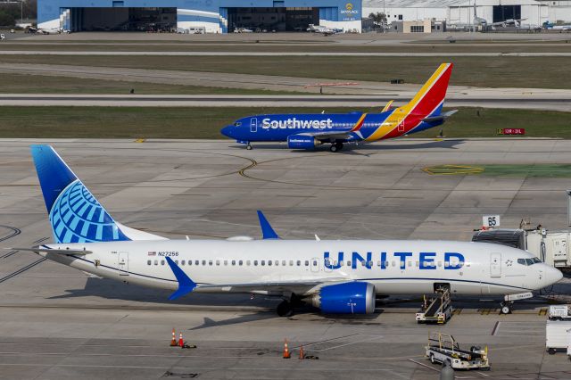 N27256 — - N919WN taxiing to 13R in background