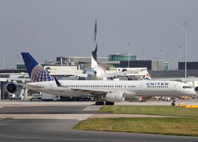 Boeing 757-200 (N48127) - A United B757-200 taxies past an Emirates A380-800 at Manchester Airport, preparing for her return Stateside.