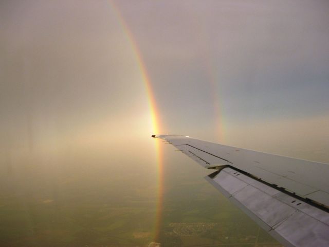 McDonnell Douglas MD-80 (MDG80) - A double rainbow follows MD-80 on its approach into RFD.