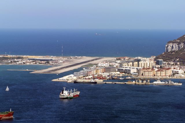 — — - Turning onto short finals for Rwy 09 at Gibraltar Airport, next to Rock of Gibraltar seen rising to right of image.