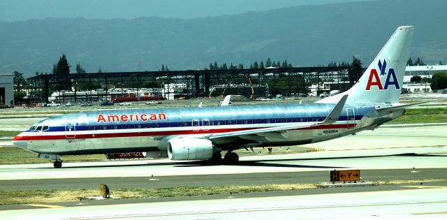 Boeing 737-800 (N849NN) - Taxiing for departure, AA # 46 to KORD  06-15-2015  (Signature Flight Services, hangers under construction in background)