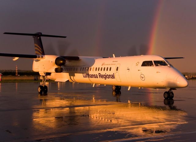 — — - A Lufthansa Dash 8 with a beautiful background