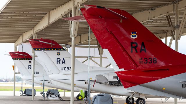 Beechcraft Beechjet (N92338) - 99th Flying Training Squadron heritage bird "338" sits among two other Red Tails under the shade at RND.