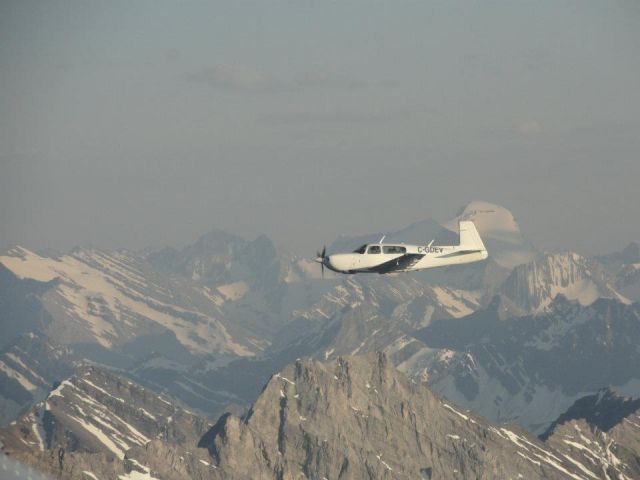 Mooney M-20 Turbo (C-GDEV) - C-GDEV over the Canadian Rockies