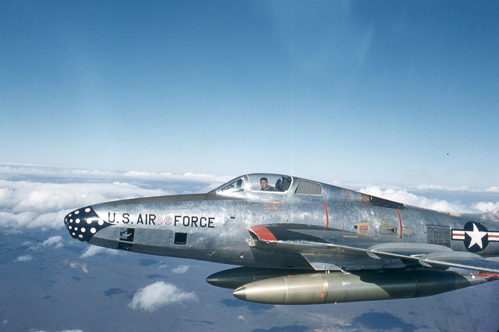 — — - Republic RF-84F- 45th Tac Recon Sqdn, 1956 over northern Japan. Pilot removed helmet momentarily for picture by wingman. 450 gal drop tanks on inboard pylons. Type servred USAF from 1954-57. First dedicated USAF jet for Tac Recce mission.
