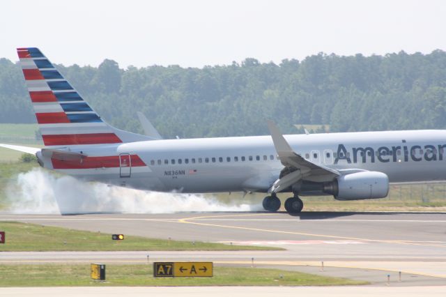 Boeing 737-800 (N836NN) - N836NN touching down runway 23L