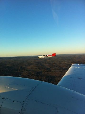 Beechcraft 35 Bonanza (N9899R) - Flying formation with a twin