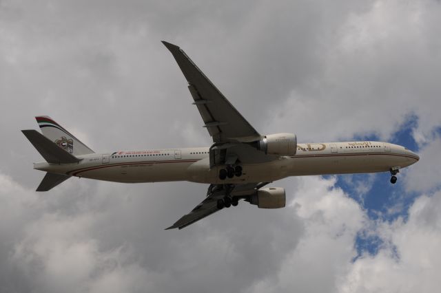 BOEING 777-300 (A6-EYI) - Formula 1 stickers on aft fuselage.