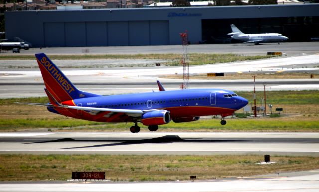 Boeing 737-700 (N919WN) - Shot from the photographers "Crows Nest" (South End of New Gaeage - 7th Floor Stair Well) overlooking the former "Terminal C"