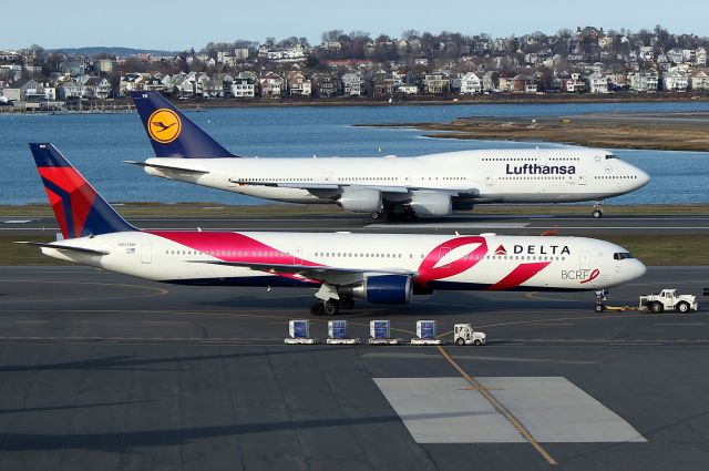 BOEING 767-400 (N845MH) - Deltas breast cancer special livery getting towed to the terminal as DLH 423 departs on 15R for Frankfurt