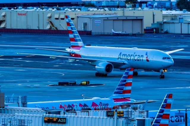 Boeing 777-200 (N757AN) - An American Airlines 777-200 taxing by the American airlines Stand Up to Cancer special livery A321 on a cloudy morning at PHX on 1/17/23. Taken with a Canon R7 and Tamron 70-200 G2 lens.