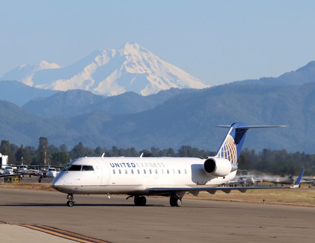 Canadair Regional Jet CRJ-200 (N937EV) - KRDD - United Express CRJ-200 arriving from San Francisco on a quiet Saturday morning. This jet had 8 passengers deplane for the terminal vs the outbound flight to SFO had about 35 pax load. Out of view to the left on the tarmac are 6 F/A-18s from MCAS Miramar VMFAT-101 Sharpshooters in town for a series of weekend training flights - in which I was waiting for 2 F/A-18s to launch when this jet landed. April 21st, 2018.