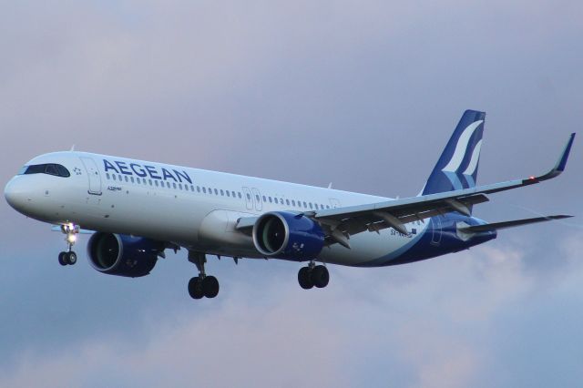 Airbus A321neo (SX-NAK) - An Aegeam A321neo on final approach into LHR, landing on runway 27L.br /br /Location: Great South West Road.br /Date: 21.12.22 (dd/mm/yy).