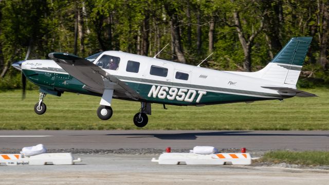 Piper Saratoga (N695DT) - N695DT rotating off of College Park Airport's runway 33 on a windy afternoon for a flight up to Pennsylvania