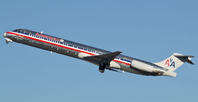 McDonnell Douglas MD-83 (N9405T) - Tucking the wheels in the wells while on the climb away from runway 16R, Americans "Flagship Tulsa" stickerbird heads into a clear blue 7 AM sky to begin a flight to Dallas.