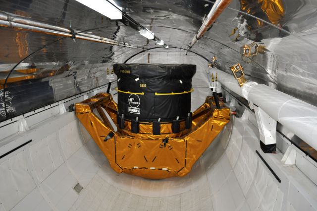 BOEING 737-300 (EXPLORER) - Mock-up of a Hughes Communications satellite (similar to one carried on STS-49) inside NASA Space Shuttle Explorer at Kennedy Space Center, Florida