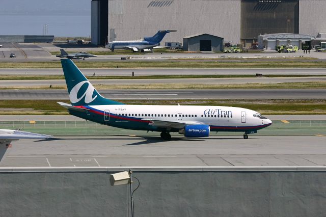 Boeing 737-700 (N173AT) - KSFO - busy ramp action as 1 of 2 F/A-18s taxis on the opposite side of the 28LR runways, and as the SFIA Fire department was holding a drill on the taxi area - and AirTran 737-7 on taxi to the terminal. Now this jet is with Southwest as N7706A.br /br /Serial number 32661 LN:1593br /Type 737-76Nbr /First flight date 11/10/2004