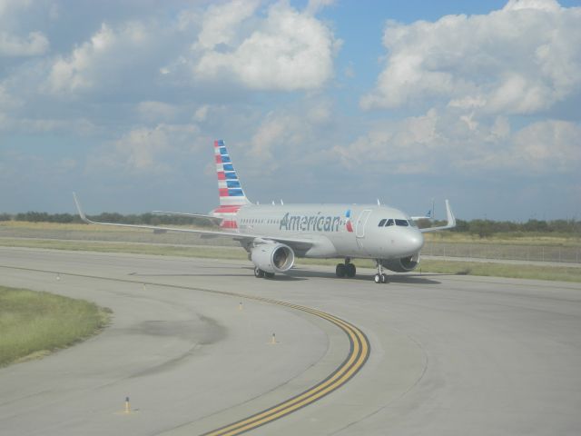 Airbus A319 (N9006) - An American Airlines A319, only a year old, taxiis off the runway on a hot October day at DFW.