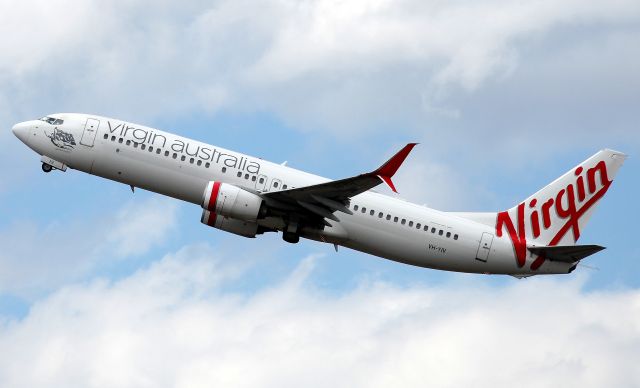 Boeing 737-800 (VH-YIV) - Climbing from Rwy 34L-first in fleet to be fitted with Scimitar Winglets.