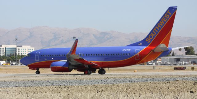 Boeing 737-700 (N739GB) - Take Off roll on 30L. Dirt pile is from construction to extend Taxiway "W" out to 30L from GA