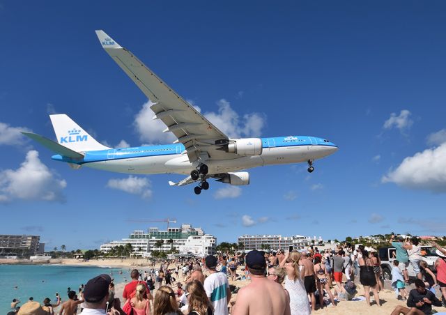 Airbus A330-300 (PH-AON) - A-330 over Maho Beach, St Maarten. Since the hurricane the beach and beach bar has been restored with continuing work to reopen the hotels and other facilities nearby. The old "blast area" on the fence is now off limits.