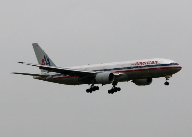 Boeing 777-200 (N774AN) - Landing on 18R at DFW. Hard to tell but the rain is coming down in buckets! Also some serious wind blowing today. Not a fun day to go flying!