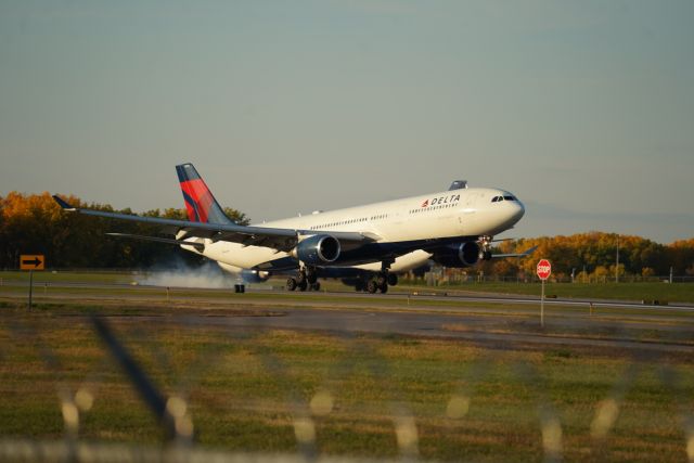 Airbus A330-300 (N826NW) - Delta a330 touching down from Paris with an a330 200 in the background. 10/22/23