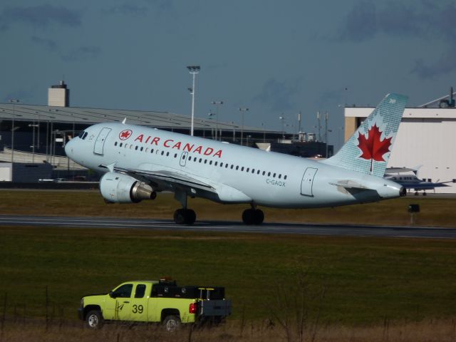 Airbus A320 (C-GAOX) - taking off of # 25 beside airport authority maintenance truck.