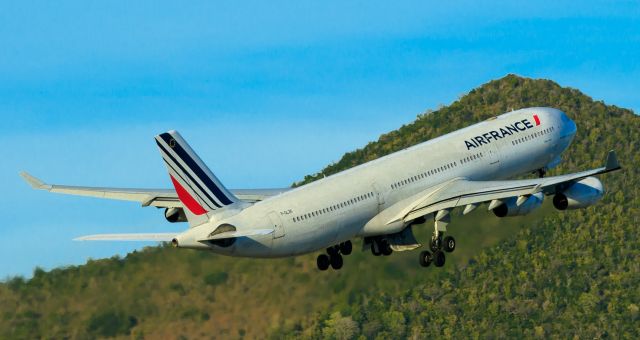 Airbus A340-300 (F-GLZK) - Air France departing TNCM climbing the hills!!