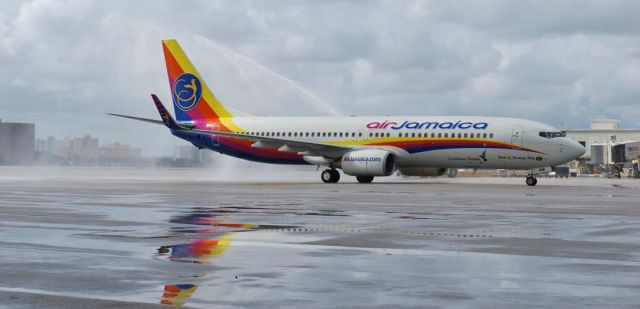 Boeing 737-800 (9Y-JME) - AIR JAMAICA MIAMI / KINGSTON INAUGURAL FLIGHT. On 09 December 2011, the Air Jamaica brand made its return to Miami. BW 21 landed at Miami International and was treated to a ceremonial water salute.