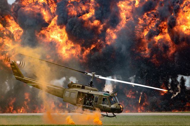 Bell UH-1V Iroquois (NX812SB) - As part of a Vietnam War reenactment during the Star Spangled Salute air show at Tinker Air Force Base, a UH-1 Huey takes off after rescuing a downed pilot as a simulated napalm bomb explodes in the background.