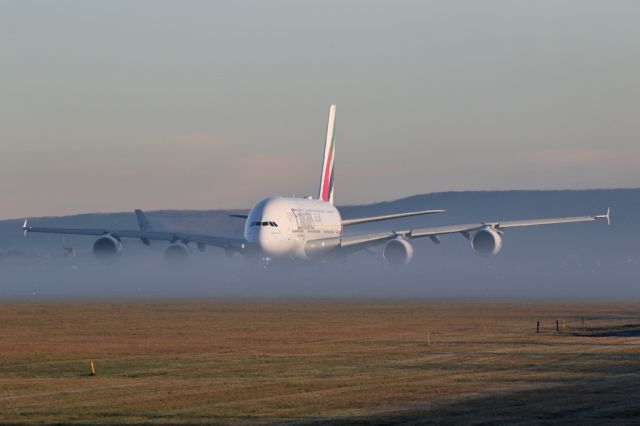 Airbus A380-800 (A6-EUP) - EK22 hiding behind some low fog from the river Bollin that passes under 23L.