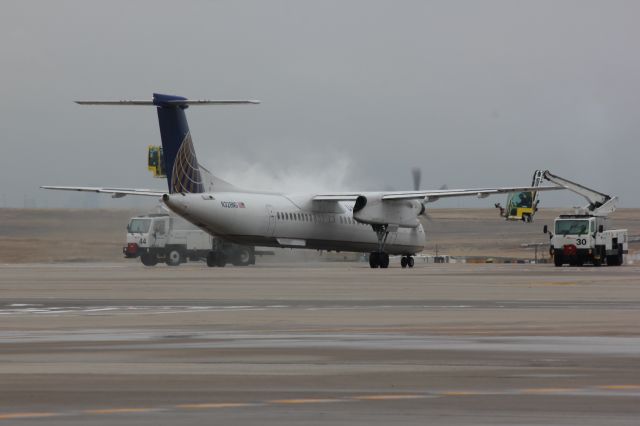 de Havilland Dash 8-400 (N328NG) - Deice operations at DIA on a cold and grey day.