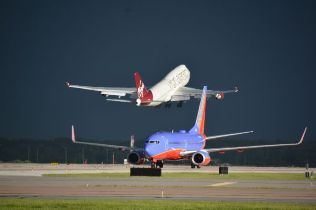 Boeing 747-400 (G-VXLG) - Take off on rwy 17R before the afternoon thunderstorms hit.Southwest taxing in on Gulf to airside 2