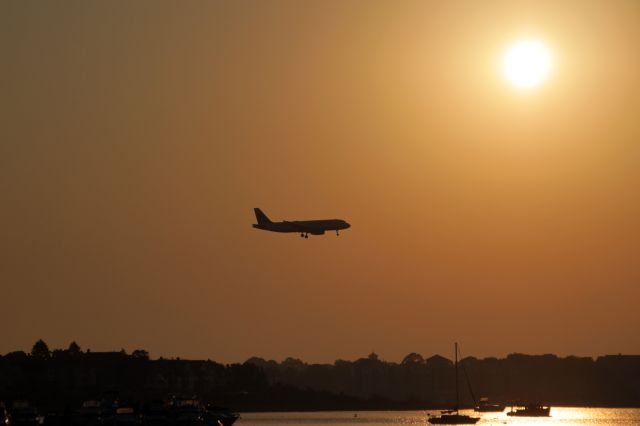 — — - Early morning flight arrives at Boston's Logan Airport