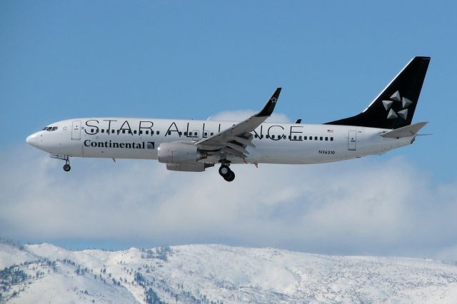 Boeing 737-800 (N26210) - On the fourth day of new direct flight service between Reno and Houstons KIAH, this "Star Alliance" schemed COA 737-800 approaches Reno Tahoe Internationals runway 16R just one day after a major snowstorm left northern Nevada looking like a crisp, clean, and glistening winter wonderland.  This photo is being posted to the FA gallery even as N26210 is enroute back to IAH on the return portion of the daily turn-around trip.