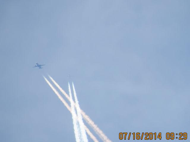 Airbus A319 (N954FR) - Frontier flight 429 (Mickey Mouse Livery) ATL to DEN crossing under an AirTran flight over the southern Missouri and Kansas state line at 36k feet.