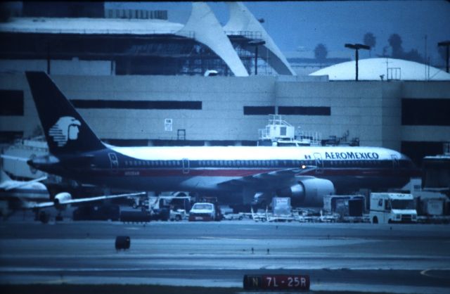 Boeing 757-200 (N806AM) - KLAX - Jan 1999 Imperial parking lot, or if my memory is fading, from Imperial Hill, shows a Aeromexico 757 at the gate. CN26273 LN:597 delv to Aeromexico Apr 1, 1994 as XA-SMM and re-reg N608AM June 14th, 1994. Color slide converted to digital.