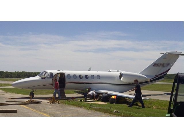 Cessna Citation CJ3 (C25B) - An unfortunate event - aircrafts landing gear got stuck in soft ground off the narrow taxiway.