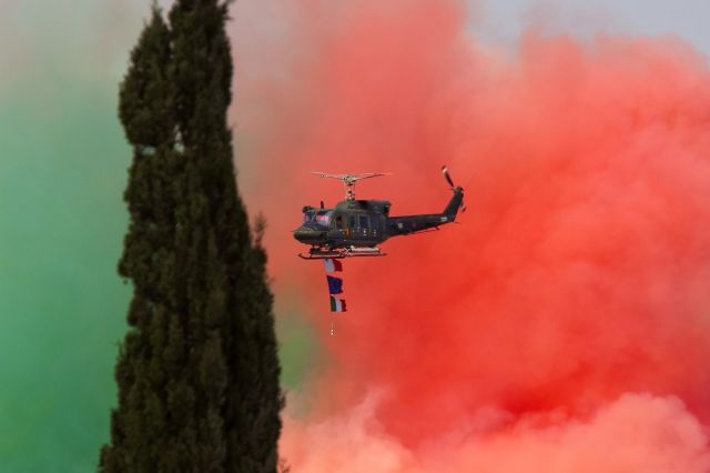 — — - Smoke from the Frecce Tricolori still on the runway.