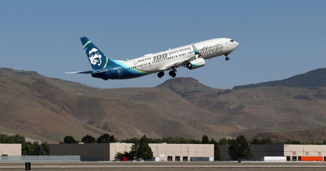 Boeing 737-900 (N248AK) - With the gear in transit as the pilots put the wheels in the wells; ASA's N248AK, wearing the "Boeing 100 Years Strong" tribute to Boeing livery scheme, is on the climb away from 17R enroute to Seattle.