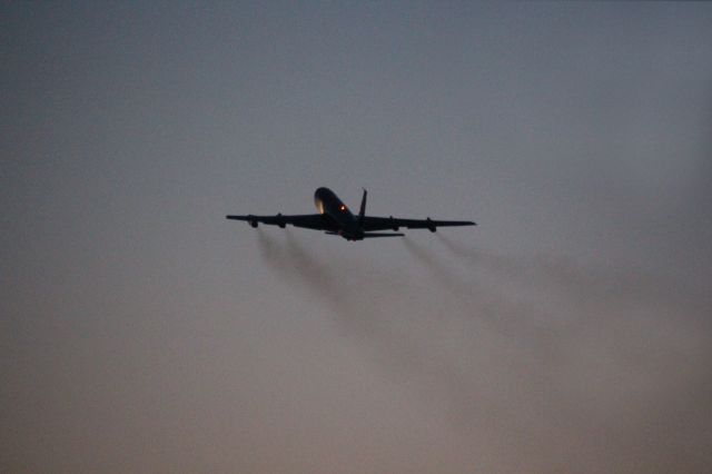 Boeing 707-100 (N707MQ) - Omega Air 707 paving a smoky path through the air after a twilight takeoff. Headed to KMWH.