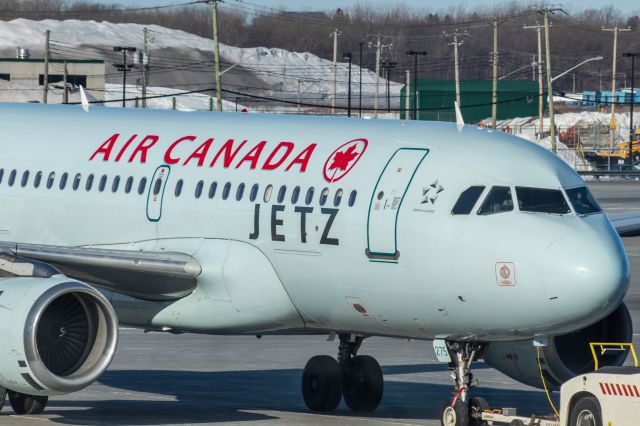 Airbus A319 (C-GBHN) - Air Canada Jetz A319 pulling into the gate at YUL.