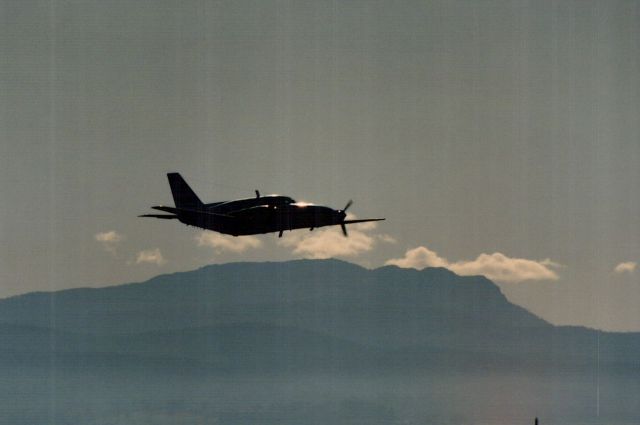 Piper Navajo (VH-HFD) - Piper Mojave VH-HFD airborne off runway 14R at Launceston, with Mt Arthur in the background.
