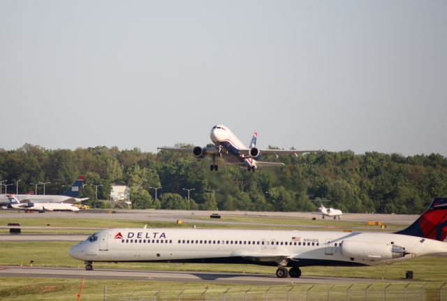 McDonnell Douglas MD-88 (N904DL) - MAY 2013, TAXIING (WAITING TO CROSS 18C) US AIR TAKING OFF IN BACKGROUND FROM 36C