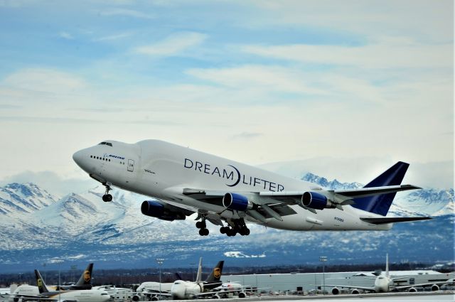 Boeing Dreamlifter (N780BA) - Standing on the west side of Ted Stevens International Airport runway. The Dreamlifter was taking off. March 5, 2019