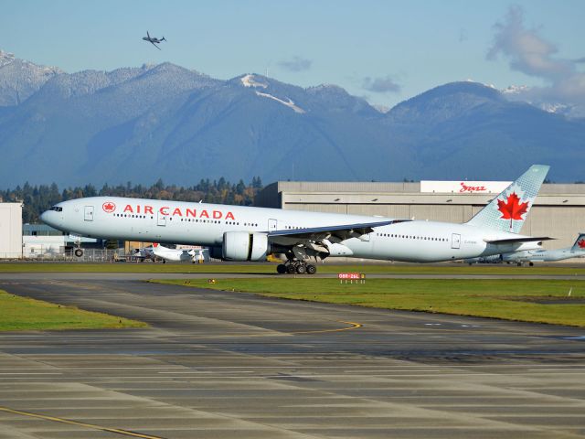 BOEING 777-300 (C-FIUW) - Vancouver International Airport (CYVR/YVR). NavCanada CRJ doing instrument check and calibration on the north runway in the back