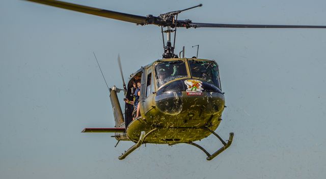 Bell UH-1V Iroquois (N354HF) - LEGACY354 returning to the "Legacy LZ" after a short flight with riders aboard. Seen here kicking up the grass while landing.