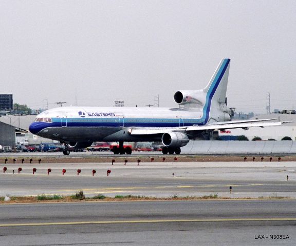 Lockheed L-1011 TriStar (N308EA) - KLAX - MIA bound L-1011 position and hold on 25R...photo from the FedEx lot.